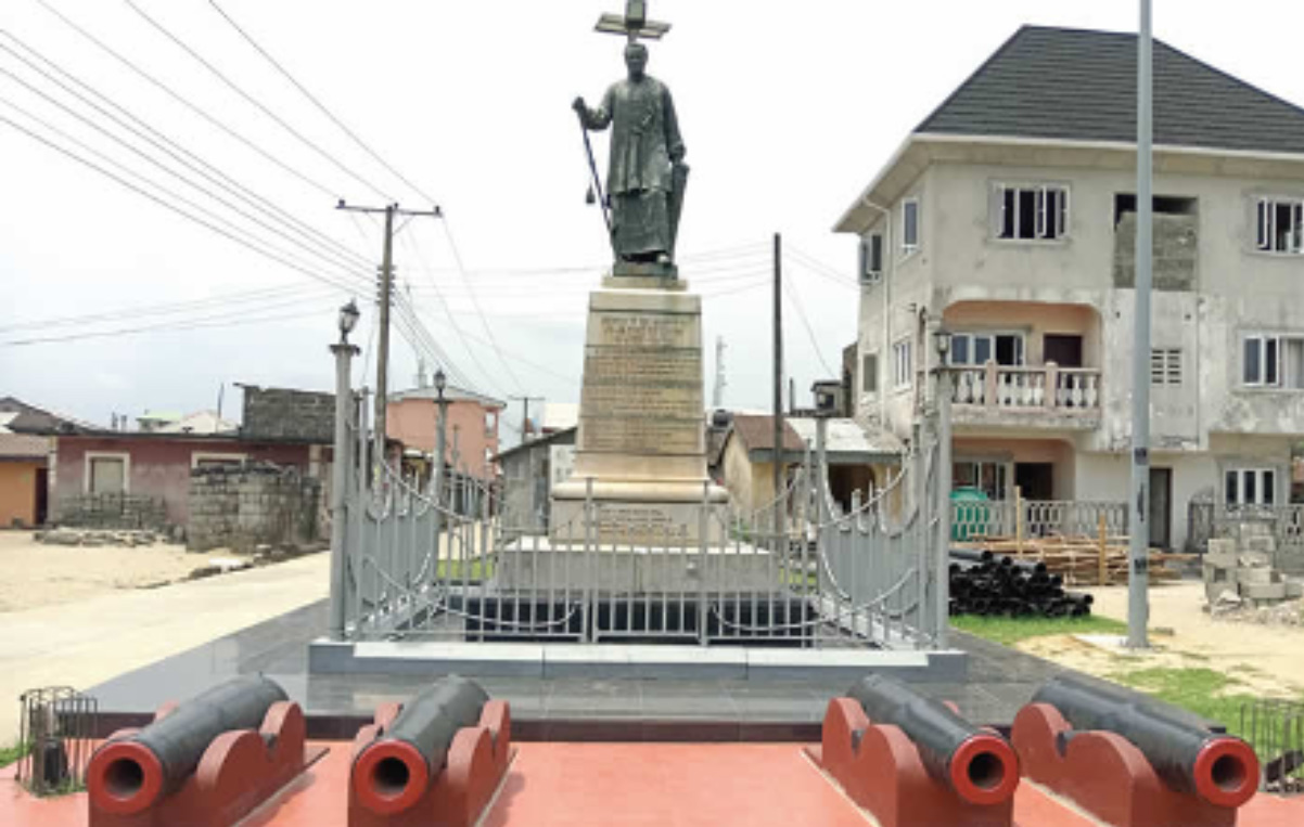 Bronze statue of King Jaja of Opobo on a plinth ringed by cannons at the town square in Opobo